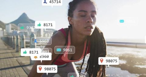 Urban athlete resting on coastal promenade with social media elements