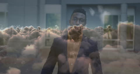 Animated Clouds Over Confident African American Businessman