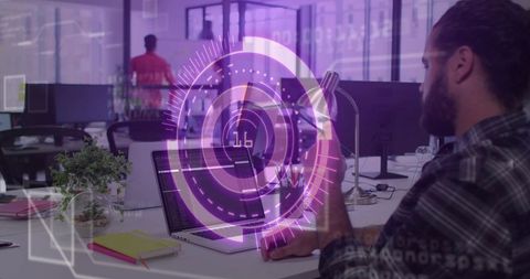 Tech Developer Working on Laptops with Futuristic Digital Overlay