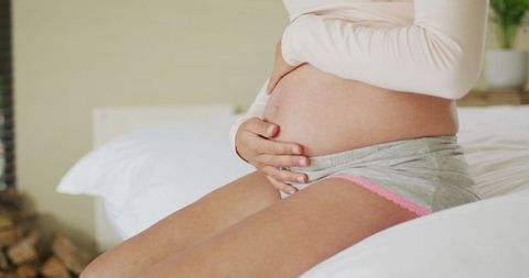 Close-Up of Pregnant Woman in Comfortable Home Setting