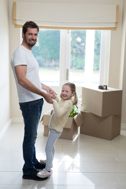 Father and daughter having fun in living room at home