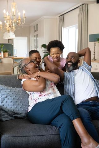 Joyful African American Family Relaxing in Cozy Living Room
