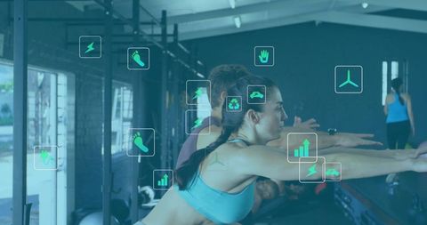 Strong woman squatting in gym with fitness icons overlay