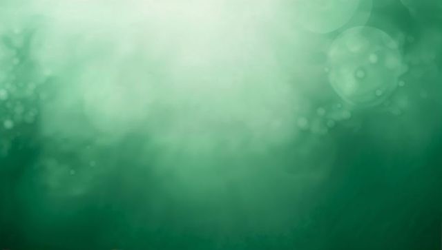 Glowing emerald underwater gradient with bokeh haze, light rays and drifting particles