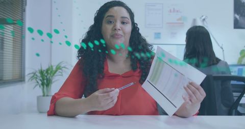 Confident Businesswoman with Data Graphics in Office Setting