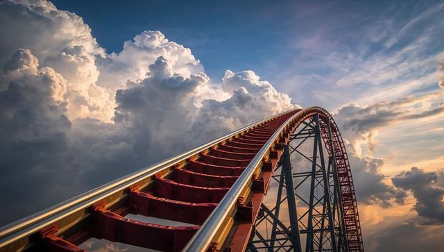 Dramatic roller coaster climb under majestic cloudscape