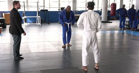 Martial Arts Training Session with Bowing Partners in Dojo