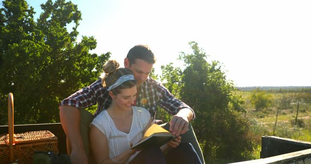 Couple Relaxing and Reading Book Outdoors in Nature - Download Free Stock Images Pikwizard.com