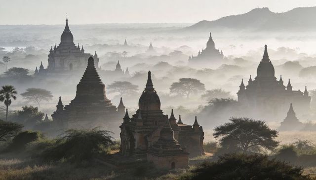 Misty bagan temple plain at sunrise with layered brick pagodas and spire silhouettes
