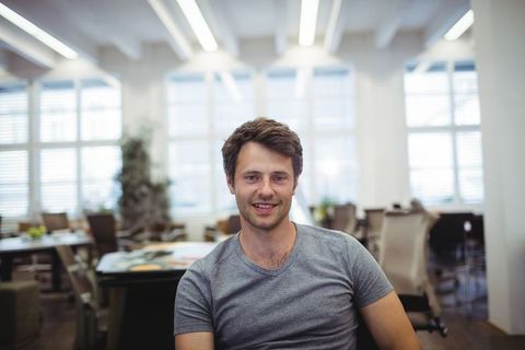 Young Professional Relaxing in Modern Office Workspace