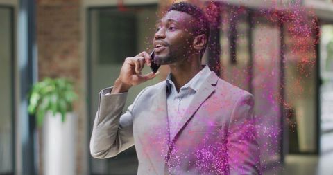 Businessman Engaged in Phone Call with Dynamic Sparkle Overlay