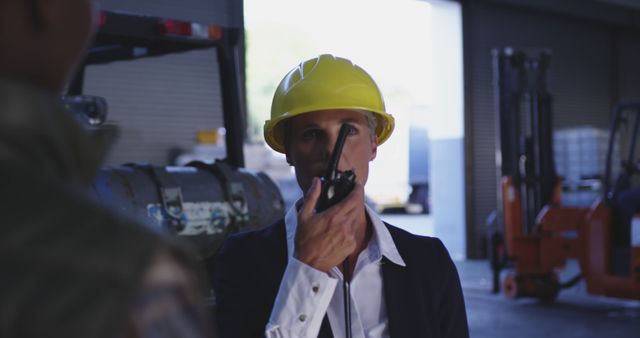 Warehouse Manager Communicating via Walkie Talkie in Industrial Space - Download Free Stock Images Pikwizard.com