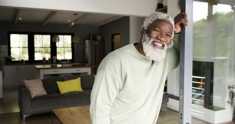 Senior African American Man Relaxing at Home by Sliding Glass Door