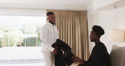 Young couple engaging in outfit preparation at home
