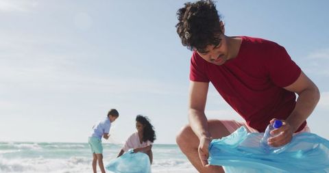 Family Collecting Trash on Beach Supporting Environmental Conservation