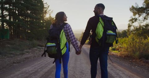 Couple Holding Hands During Countryside Evening Trek - Download Free Stock Images Pikwizard.com
