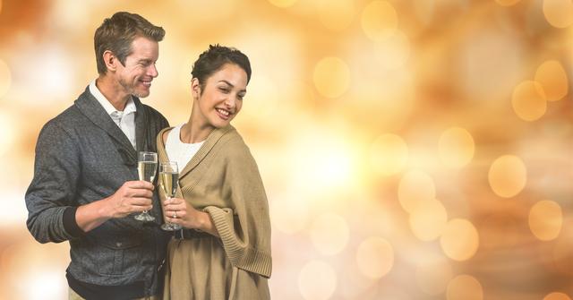 Digital composite of Happy couple holding champagne flutes over blur background