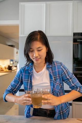 Contemporary Kitchen with Woman Holding Coffee Glasses