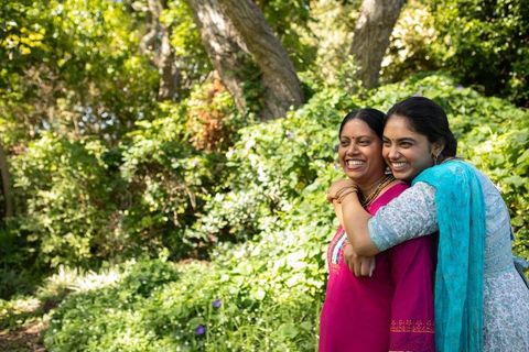 Happy Mother and Daughter Enjoying Time in Sunlit Garden