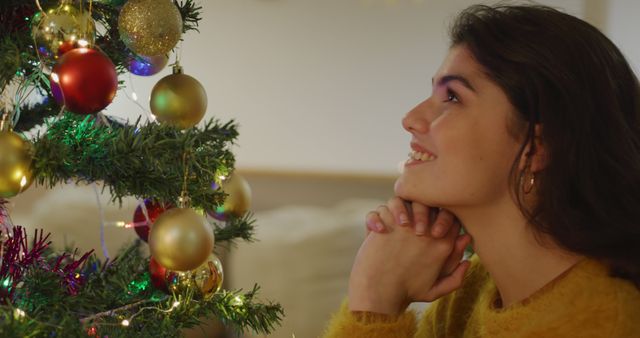 Woman Admiring Decorated Christmas Tree with Joyful Expression - Download Free Stock Images Pikwizard.com