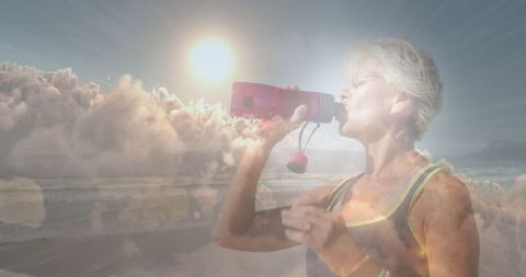 Active Senior Woman Drinking Water Under Glowing Sunlight