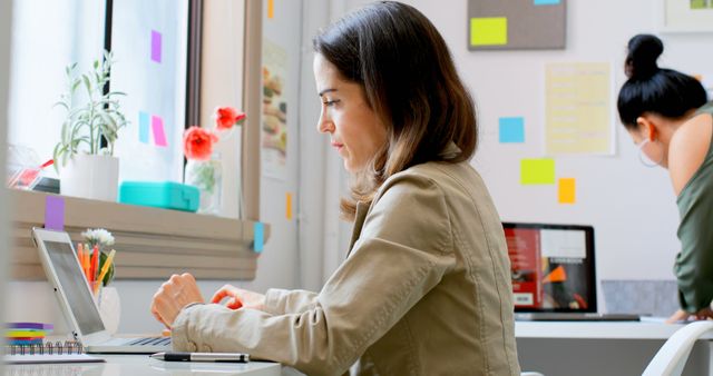 Focused Businesswoman Working on Laptop in Contemporary Office - Download Free Stock Images Pikwizard.com