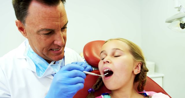 Dentist Examining Young Girl's Teeth in Dental Clinic - Download Free Stock Images Pikwizard.com