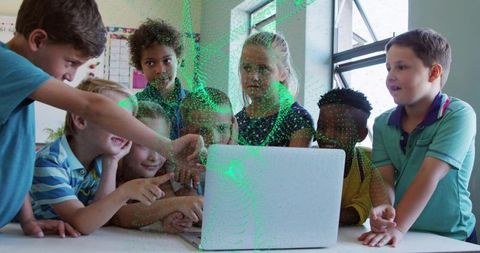 Elementary students collaborating around laptop classroom engaging with digital learning