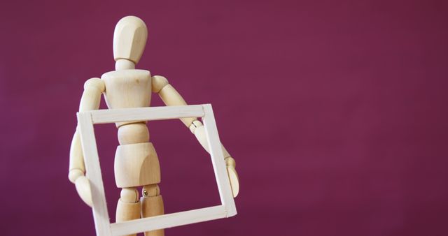 Conceptual image of figurine holding wooden picture frame 4k - Download Free Stock Photos Pikwizard.com