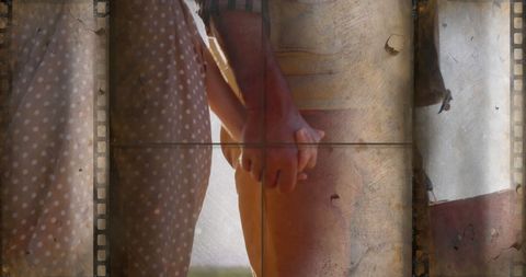 Vintage couple holding hands overlaid with film strips