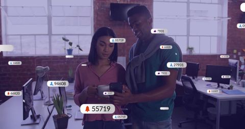 Diverse Colleagues Analyzing Social Media Data in Modern Office