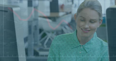 Smiling Businesswoman Analyzing Financial Data on Computer