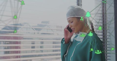 Asian female doctor using smartphone with digital interface icons