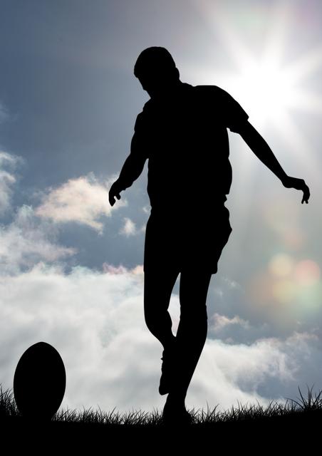 Silhouette of a rugby player kicking a ball on a sunny day with a bright sky and clouds in the background. Ideal for use in sports promotions, athletic event advertisements, motivational posters, and outdoor activity campaigns.