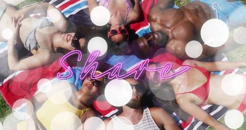 Friends Relaxing on Towels with Neon Share Message