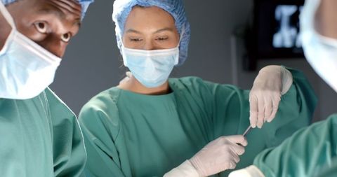 Medical team conducting surgical operation in hospital operating room