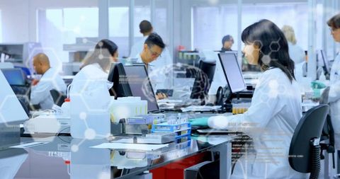 Diverse scientists working in laboratory with digital interface overlay