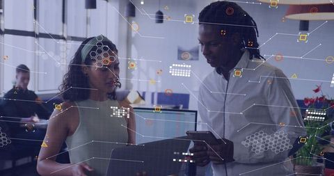 Young professionals collaborating with ar overlays in modern office using tablet and phone