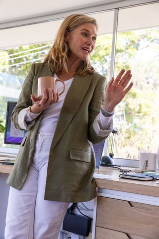 Professional woman engaging in office discussion with a coffee