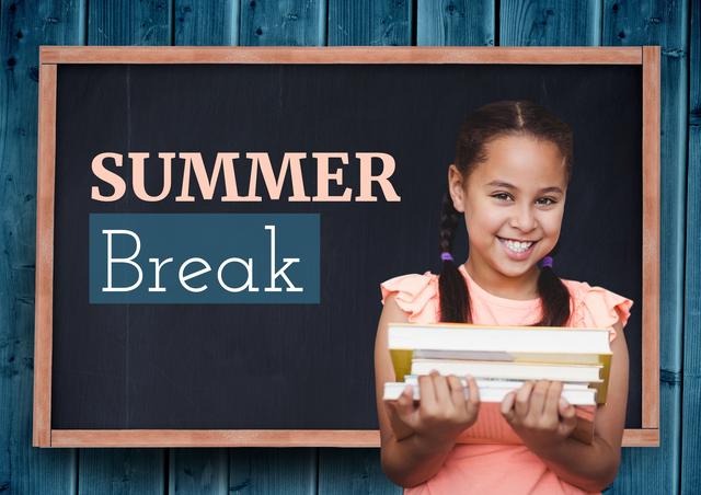 Happy schoolgirl holding a stack of books in front of blackboard with 'Summer Break' written on it, making it ideal for educational materials, school-related advertisements, or summer programs for children. Perfect for promoting back-to-school campaigns or summer reading programs.