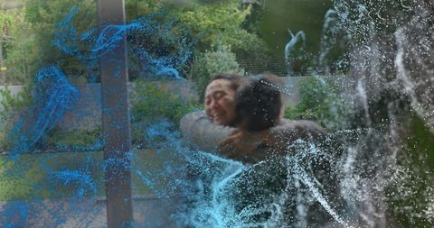 Korean couple hugging through glass door with blue particle overlay intimate outdoor embrace