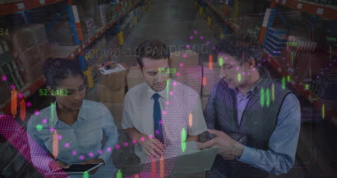 Diverse Business Team Analyzing Financial Data In Warehouse Setting