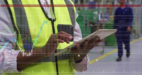 Warehouse worker tapping tablet with AR overlay showing logistics data and analytics