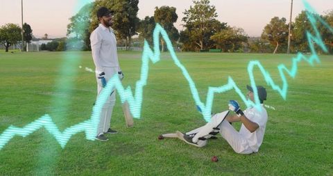 Two cricketers laughing after fallen batsman during park practice with waveform overlay