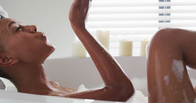 Woman Relaxing in Bubble Bath Blowing Kiss - Download Free Stock Images Pikwizard.com