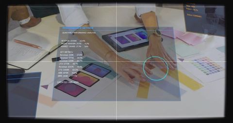 Three women collaborating and reviewing app mockups and color swatches with tablet hud
