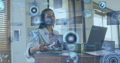 Professional Woman Engaging with Holographic Data and Laptop in Modern Office