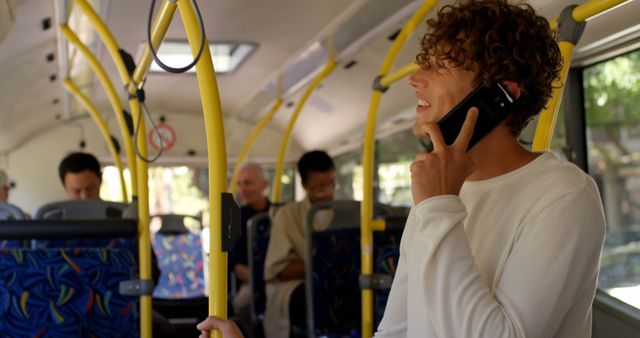 Young man talking on mobile phone while commuting in city bus - Download Free Stock Images Pikwizard.com