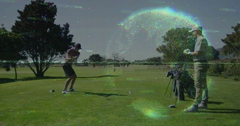 Golfer swinging at tee with companion watching by bag and digital globe glitch overlay
