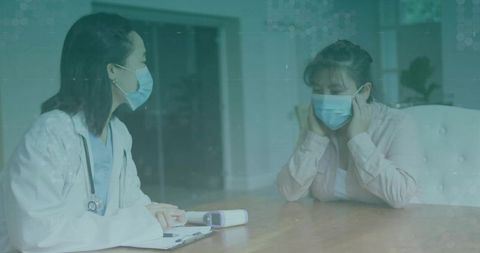 Female doctor consults masked patient in clinic setting